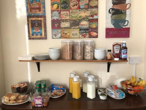 a table with plates of food on a shelf at Chadwick Guest House in Middlesbrough