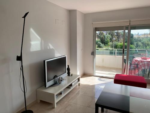 a living room with a flat screen tv on a table at Aquamaris-Denia Apartamento espectacular in Denia