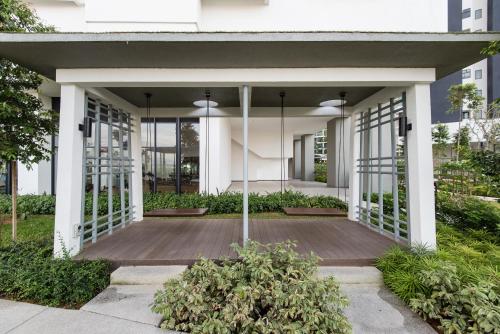 a large white building with a wooden porch at 3 Rooms Elegant Minimalist Design Setapak 15min KLCC in Kuala Lumpur