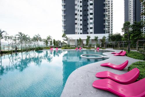 a large swimming pool with pink plastic slippers at 3 Rooms Elegant Minimalist Design Setapak 15min KLCC in Kuala Lumpur