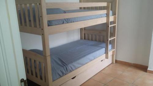 a couple of bunk beds in a room at Apartamentos Patrisol in Zahara de los Atunes