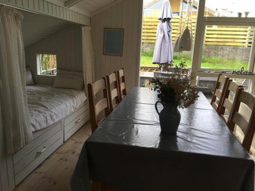 a room with a table with a bed and a bed at Two-Bedroom Holiday Home for 6 in Vemmingbund in Broager