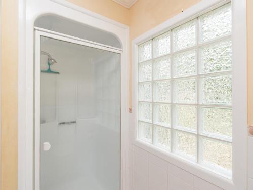 a bathroom with a shower and a window at Captain's Quarters - Opua Holiday Home in Opua