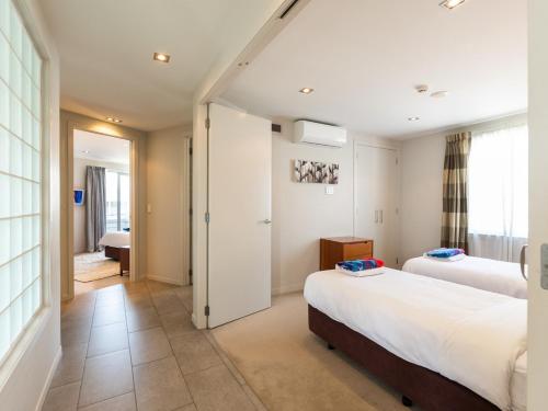 a hotel room with two beds and a window at High Tides Lookout - Paihia Holiday Home in Paihia