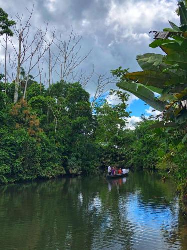 a group of people in a boat on a river at Misahualli Laguna Paikawe B&B in Puerto Misahuallí