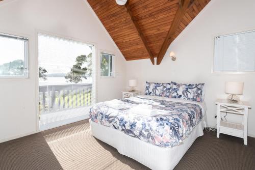 Un ou plusieurs lits dans un hébergement de l'établissement Wairangi Beach Cottage - Paihia Beach House