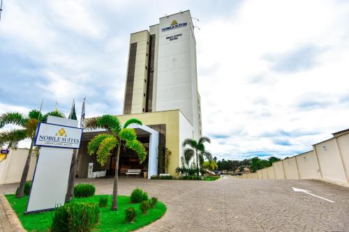 a large white building with a clock tower at Nobile Suites Gran Lumni in Rio Branco