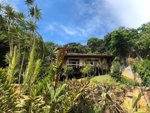 a house in the middle of a jungle with trees at Pousada Encanto de Búzios in Búzios