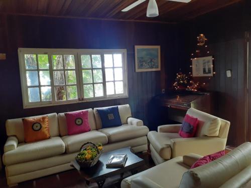 a living room with a couch and two couches at Pousada D'Aconchego Nova Brasilia in Ilha do Mel