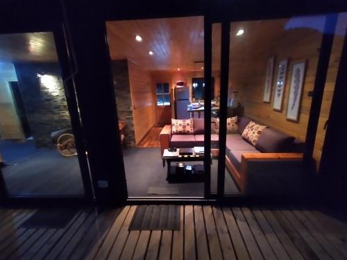 a view of a living room through a glass door at La Quebrada in Navidad