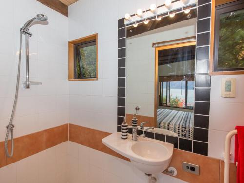 a bathroom with a sink and a shower at Crows Nest - Queenstown Holiday Home in Queenstown