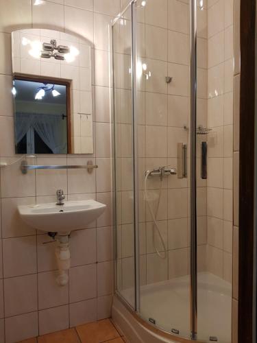 a bathroom with a shower and a sink at Pokoje Relaks 2 in Gdynia