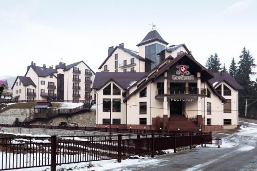 a large white building with aasteryasteryasteryasteryasteryasteryasteryasteryasteryastery at GasthauS & SPA in Bukovel