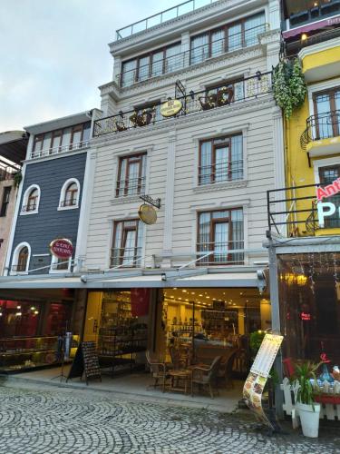 a large white building with tables in front of it at Magnaura House Hotel in Istanbul