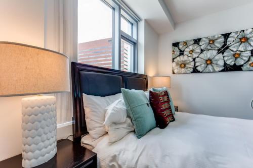 a bedroom with a bed and a large window at Global Luxury Suites at Kendall East in Cambridge