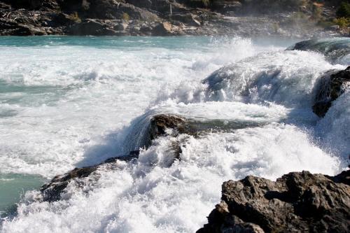 a river with water rushing over the rocks at Lodge El Mirador De Guadal in Puerto Guadal