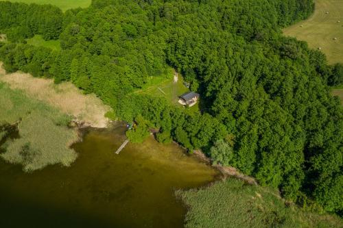an aerial view of a house in the middle of a forest at Domki nad Jeziorem in Rajgród