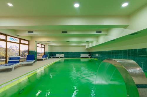 a swimming pool with a fountain in a building at Ski Hotel in Žabljak
