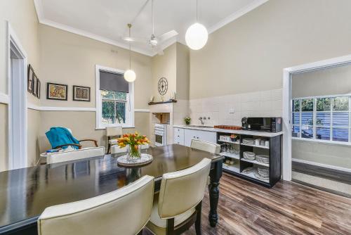 a kitchen with a dining room table and chairs at The Jazz B&B in Naracoorte