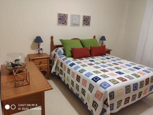 a bedroom with a bed with a colorful bedspread at SATI 2 A in Santa Cruz de la Palma