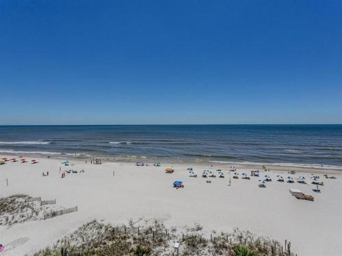 a beach with a lot of people and the ocean at Tradewinds Condos II in Orange Beach