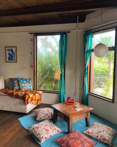 a living room with a couch and a table at Pousada Gopak in Praia do Rosa