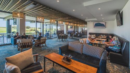 a lobby with couches and tables and people sitting at Best Western City Sands in Wollongong