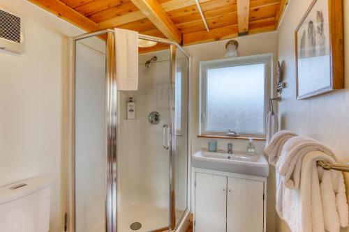 a bathroom with a shower and a sink at Sequoia Cottage in Eureka
