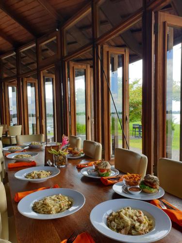 a long table with plates of food on it at Houttuyn Wellness River Resort in Paramaribo