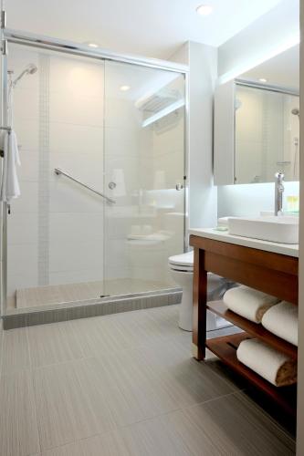 a bathroom with a shower and a sink and a toilet at Hyatt Place Lincoln/Downtown-Haymarket in Lincoln