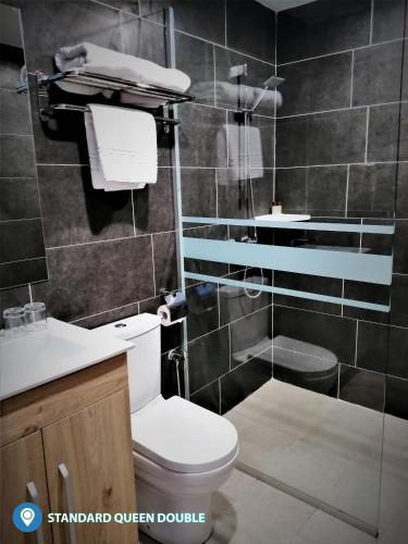 a bathroom with a toilet and a glass shower at Desa Selatan Resort Pengerang in Pengerang