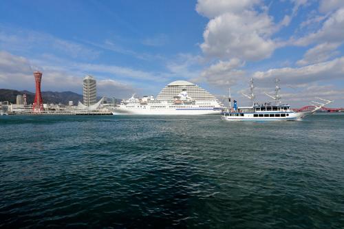two cruise ships in the water near a city at Hotel Monterey Kobe in Kobe