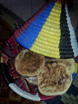 a plate of food with three tortillaas on a table at Maison d hôtes Tioute Chez Abdelmajid in Tiout