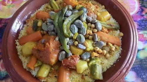 a brown bowl of food with beans and vegetables at Maison d hôtes Tioute Chez Abdelmajid in Tiout