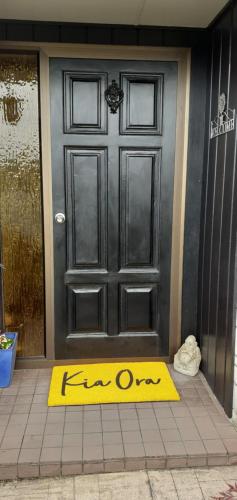 a yellow welcome mat in front of a door at 66 Chaucer B&B with Complimentary Breakfast in Cambridge