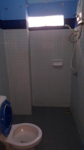 a small bathroom with a toilet and a light at Mr. Clean Guesthouse in Krabi town