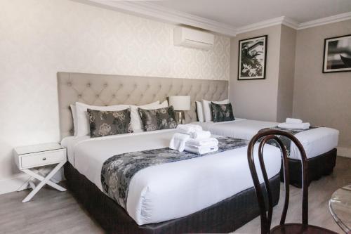 A bed or beds in a room at The Lurline Randwick