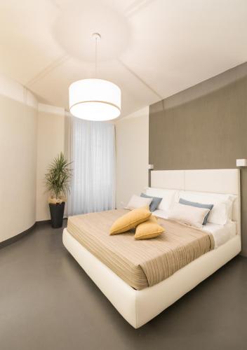 a bedroom with a large bed with pillows on it at LUCUS Exclusive Bed and Breakfast in Lucca