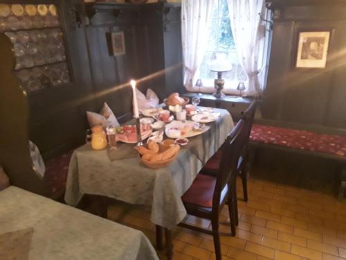 a dining room with a table with a candle on it at Hotel Feiler in Muggendorf
