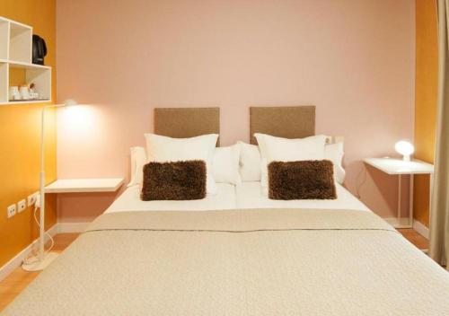 a bedroom with a large white bed with two pillows at BYPILLOW Villa Lorena Adults Recommended in Málaga