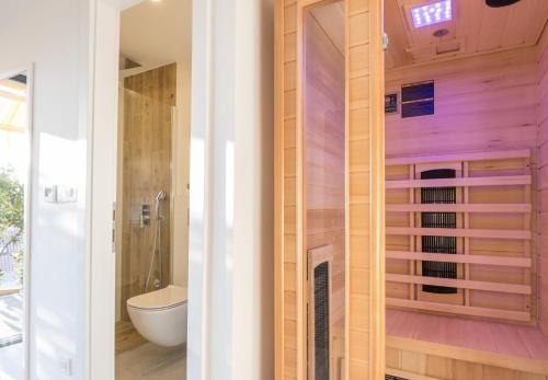 a bathroom with a toilet and a sink at MORE Podgora Luxury Design Apartment in Podgora