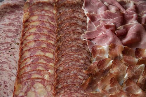a close up of a pizza with ham and cheese at Landgasthof Jagerwirt in Volders