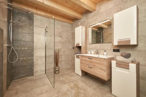 a bathroom with a shower and a sink at das Blockhittle in Sautens