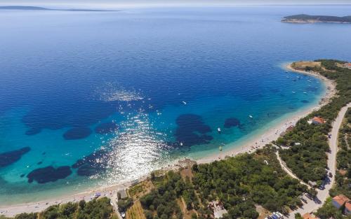 an aerial view of a beach with a boat in the water at Hacienda Babina in Miholašćica