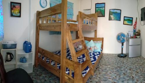 a bedroom with two bunk beds in a room at Bolo Beach Santorini nearby to Hundred Island in Alaminos