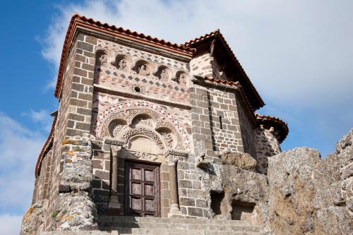 a tower of a building with a window at ibis Styles Le Puy en Velay in Le Puy en Velay