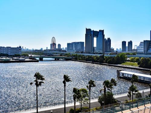 a large body of water with a city in the background at Far East Village Hotel Tokyo Ariake in Tokyo