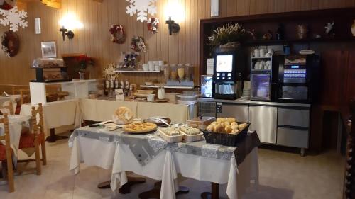 a kitchen with a table with food on it at Hotel Europa in Bardonecchia