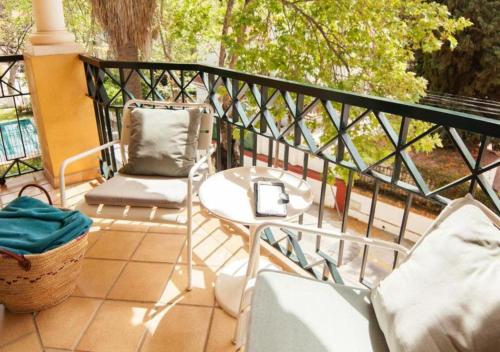 a patio with two chairs and a table on a balcony at BYPILLOW Villa Lorena Adults Recommended in Málaga