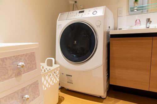 a washing machine in a kitchen next to a sink at belle lune hotel hakata Suite Room 1 in Fukuoka